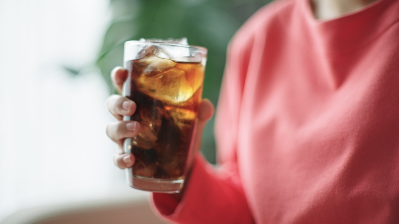 A woman is drinking Coke and is unaware of the sugar content in North Phoenix, AZ