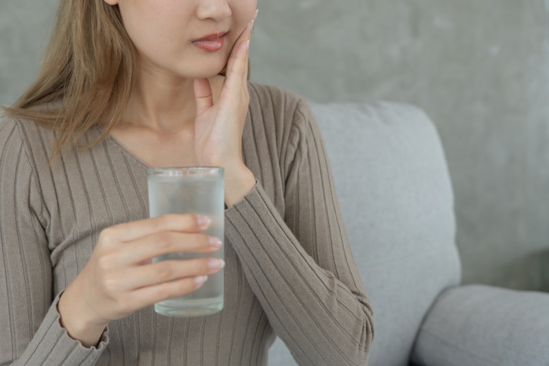 A woman who feels sensitive teeth rely on home remedies for relief in North Phoenix, AZ